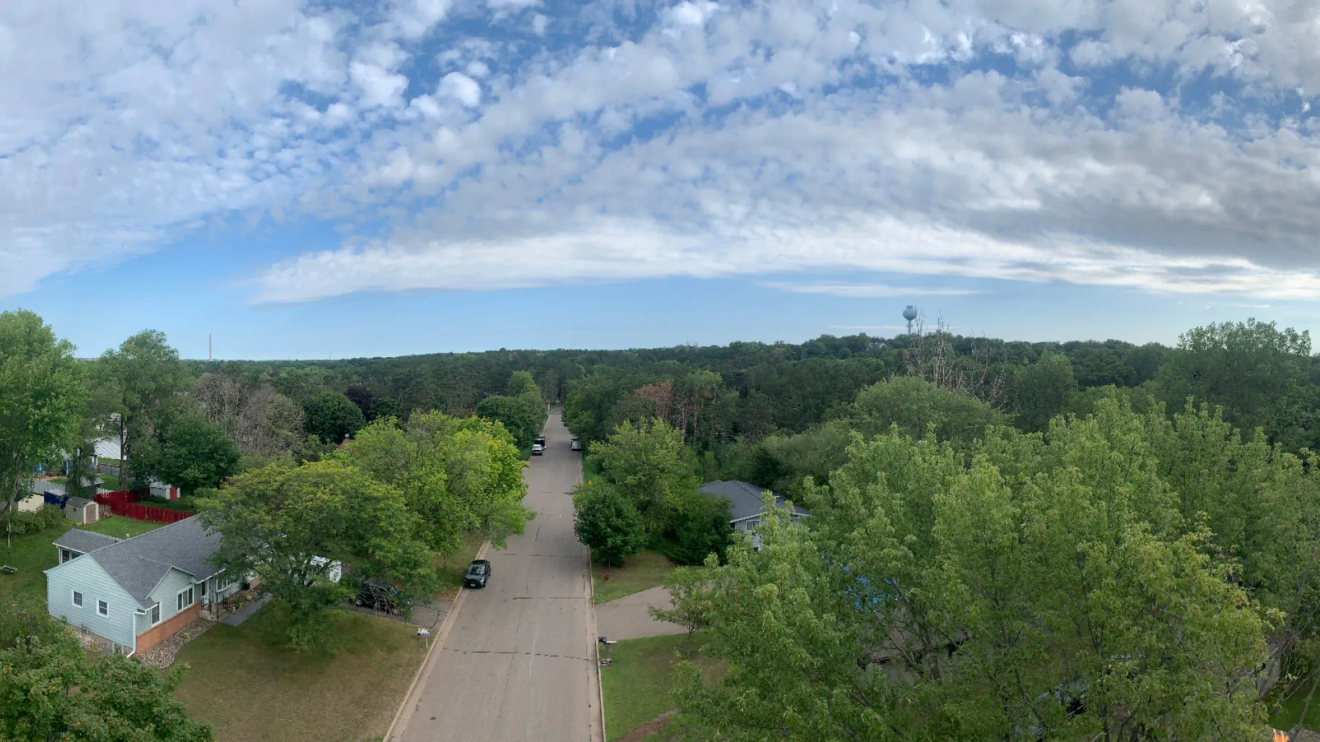 aerial shot of residential houses surrounded by trees